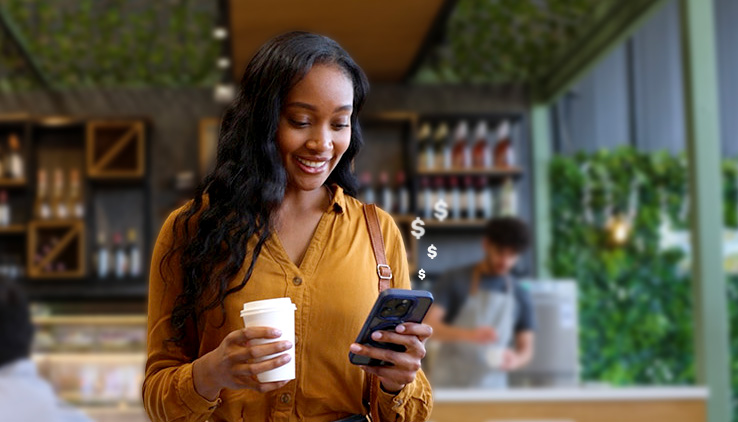 Woman using phone in cafe with money symbols floating from phone symbolizing passive savings growth