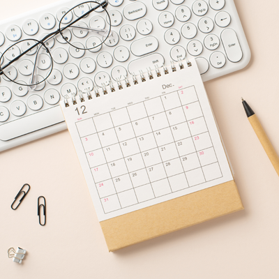 Keyboard beside an appointments calendar representing online scheduling and planning
