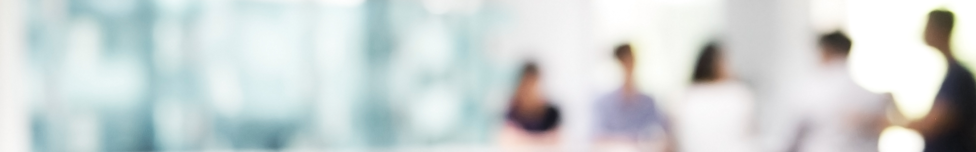 Blurred image of group of people collaborating around an office desk