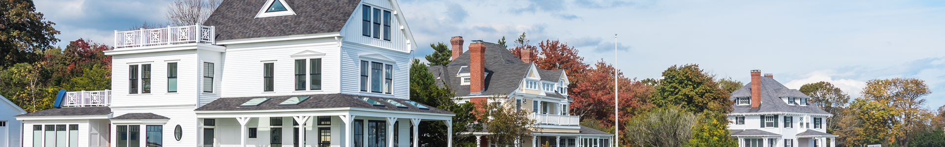 Three white new england colonial homes in the autumn